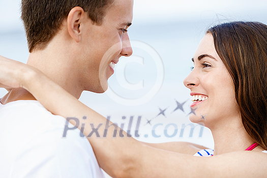 Portraits of romantic young couple on the beach Portraits of romantic young couple on the beach