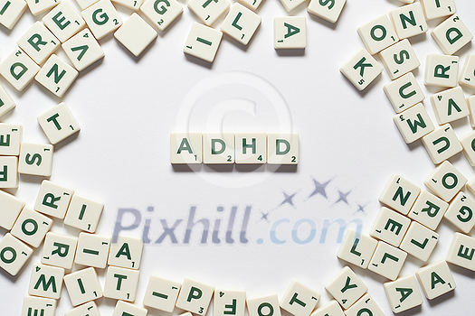 ADHD abbreviation formed of scrabble blocks over white background. Attention deficit hyperactivity disorder and mental health awareness. ADHD abbreviation formed of scrabble blocks over white background. Attention deficit hyperactivity disorder and mental health awareness.