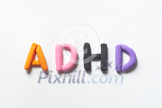 ADHD abbreviation formed of colorful plasticine on white background. Attention deficit hyperactivity disorder and mental health awareness. ADHD abbreviation formed of colorful plasticine on white background. Attention deficit hyperactivity disorder and mental health awareness.