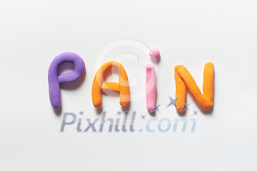 Pain word formed of colorful plasticine on white background. Pain word formed of colorful plasticine on white background.