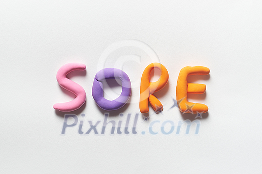 Sore word formed of colored plasticine on white backdrop. Sore word formed of colored plasticine on white backdrop.