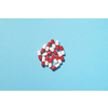 Red and white pharmaceutical tablets scattered over blue backdrop, copy space. Health care and medication-assisted treatment.