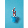 Pharmaceutical pills falling out of bucket over blue background. Top view with copy space.