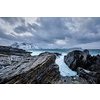 Waves of Norwegian sea crushing at rocky coast in fjord. Vikten, Lofoten islands, Norway