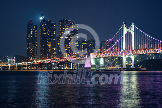 Gwangan Bridge and skyscrapers illuminated in the night. Busan, South Korea Gwangan Bridge and skyscrapers illuminated in the night. Busan, South Korea