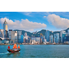 Hong Kong skyline cityscape downtown skyscrapers over Victoria Harbour in the evening with junk tourist ferry boat on sunset with dramatic sky. Hong Kong, China