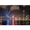 Hong Kong skyline cityscape downtown skyscrapers over Victoria Harbour in the evening illuminated with lasers with tourist boat ferries . Hong Kong, China