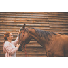 Pretty, young, redhead woman with her lovely horse, during her favorite leisure