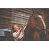 Pretty, young, redhead woman with her lovely horse, during her favorite leisure