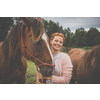 Pretty, young, redhead woman with her lovely horse, during her favorite leisure