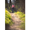 Pretty, young woman with her mountain bike going for a ride past the city limits, getting the daily dose of cardio