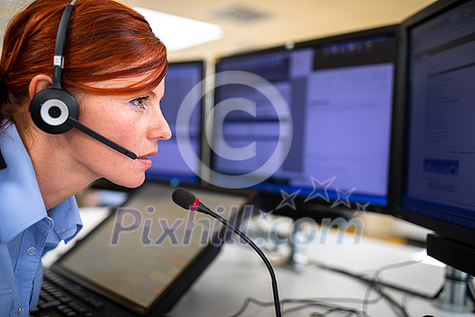 Call centre employee communicating over phone using an external microphone for better sounf and ergonomics Call centre employee communicating over phone using an external microphone for better sounf and ergonomics