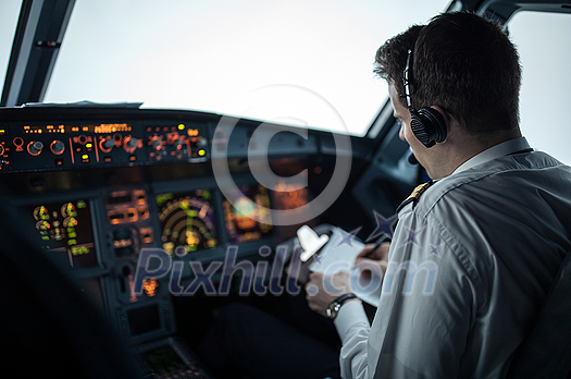 Pilot's hand accelerating on the throttle in a commercial airliner airplane flight cockpit during takeoff Pilot's hand accelerating on the throttle in a commercial airliner airplane flight cockpit during takeoff