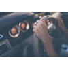 Pretty, young woman  driving a car -Invitation to travel. Car rental or vacation.