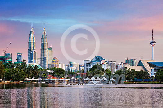 KUALA LUMPUR, MALAYSIA - JUNE 19, 2011: Kuala Lumpur skyline with Petronas Twin Towers skyscrapers on sunset. View over Titiwangsa Lake. Kuala Lumpur, Malaysia KUALA LUMPUR, MALAYSIA - JUNE 19, 2011: Kuala Lumpur skyline with Petronas Twin Towers skyscrapers on sunset. View over Titiwangsa Lake. Kuala Lumpur, Malaysia