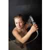 Pretty,young woman taking a long hot shower in a modern bathroom