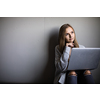 Pretty, young woman with her laptop studying for an exam/working