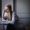 Pretty, young woman with her laptop studying for an exam/working