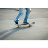 Skateboarder riding fast towards the ramps to be lifted into the air and perform a trick