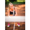 Pretty, young woman tennis player playing on a clay court. Healthy active lifestyle concept