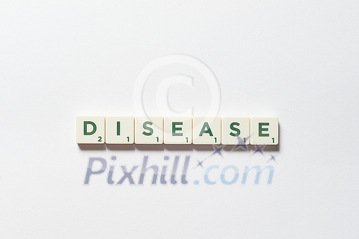 Disease word formed of scrabble blocks on white background. Disease prevention and physical health awareness. Disease word formed of scrabble blocks on white background. Disease prevention and physical health awareness.