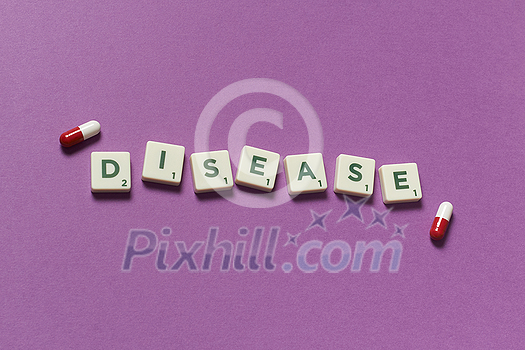 Disease word formed of scrabble blocks and pharmaceutical pills over purple background. Health and medical treatment concept. Disease word formed of scrabble blocks and pharmaceutical pills over purple background. Health and medical treatment concept.