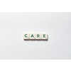 Care word formed of scrabble blocks over white background. Health insurance and protection concept.