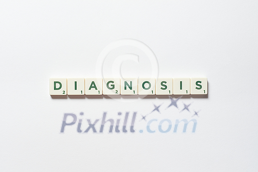 Diagnosis word formed of scrabble blocks on white background. Disease prevention and physical health awareness. Diagnosis word formed of scrabble blocks on white background. Disease prevention and physical health awareness.