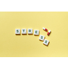 Stress word formed of scrabble tiles and pharmaceutical pills on yellow background. Mental health awareness.