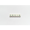 Covid word formed of scrabble blocks on white background. Coronavirus infection and medical treatment concept.