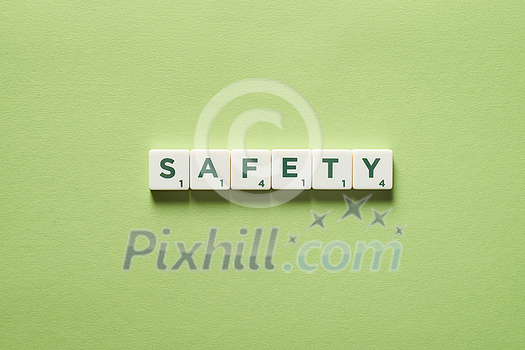 Safety word formed of scrabble tiles on green background. Safety word formed of scrabble tiles on green background.