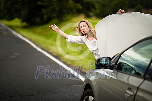 Pretty middle aged woman having car troubles - broken down car on the side of the road, calling the insurance company for assistance Pretty middle aged woman having car troubles - broken down car on the side of the road, calling the insurance company for assistance