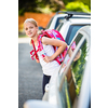 Cute little girl going home from school, looking well before crossing the street