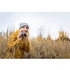 Young woman with binoculars outdoors on fall day. Enjoying the outdoors.
