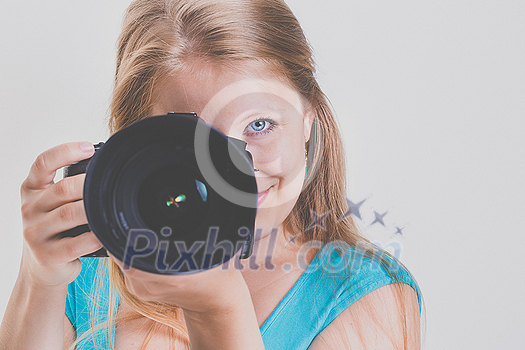 Pretty, female photographer with her digital camera (color toned image; shallow DOF) Pretty, female photographer with her digital camera (color toned image; shallow DOF)