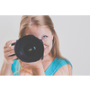 Pretty, female photographer with her digital camera (color toned image; shallow DOF)