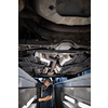 Car mechanic under a car in a repair shop/car garage (shallow DOF/color toned image)