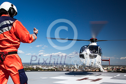 Modern medical helicopter on a hospital rooftop helipad Modern medical helicopter on a hospital rooftop helipad