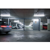 Underground parking. Cars parked in a garage with no people. Many cars in parking garage interior. Underground parking with cars (color toned image)