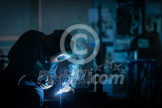 Man working on iron with grinder. Man at work. Sparkles and fire from grinder cutting. Grinder. Worker. Man working on iron with grinder. Man at work. Sparkles and fire from grinder cutting. Grinder. Worker.