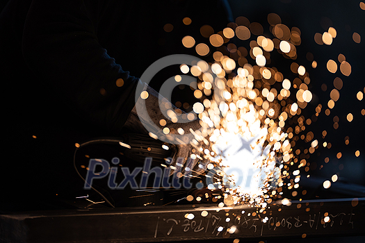 Man working on iron with grinder. Man at work. Sparkles and fire from grinder cutting. Grinder. Worker. Man working on iron with grinder. Man at work. Sparkles and fire from grinder cutting. Grinder. Worker.