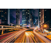 Street traffic in Hong Kong at night. Office skyscraper buildings and busy traffic on highway road with blurred cars light trails. Hong Kong, China