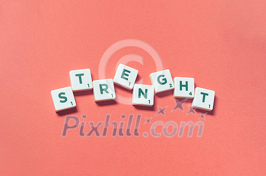 Strength word formed of scrabble blocks on red background. Creative template with copy space. Strength word formed of scrabble blocks on red background. Creative template with copy space.