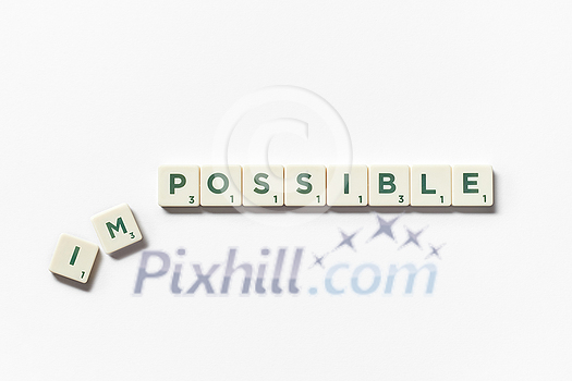 Impossible turning into Possible word made of scrabble blocks with on white background. Impossible turning into Possible word made of scrabble blocks with on white background.