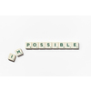 Impossible turning into Possible word made of scrabble blocks with on white background.