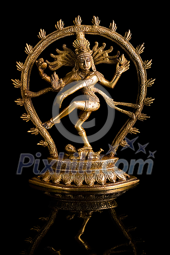 Statue of indian hindu god Shiva Nataraja - Lord of Dance on black background with reflection Statue of indian hindu god Shiva Nataraja - Lord of Dance on black background with reflection