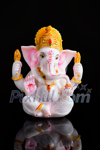 Ganesha statue isolated on black background with reflection Ganesha statue isolated on black background with reflection