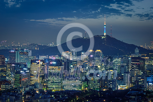 Seoul downtown cityscape illuminated with lights and Namsan Seoul Tower in the evening view from Inwang mountain. Seoul, South Korea. Seoul downtown cityscape illuminated with lights and Namsan Seoul Tower in the evening view from Inwang mountain. Seoul, South Korea.