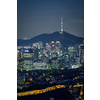 Seoul downtown cityscape illuminated with lights and Namsan Seoul Tower in the evening view from Inwang mountain. Seoul, South Korea.