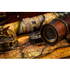 Travel geography navigation concept background - old vintage retro compass with sundial, spyglass on ancient world map